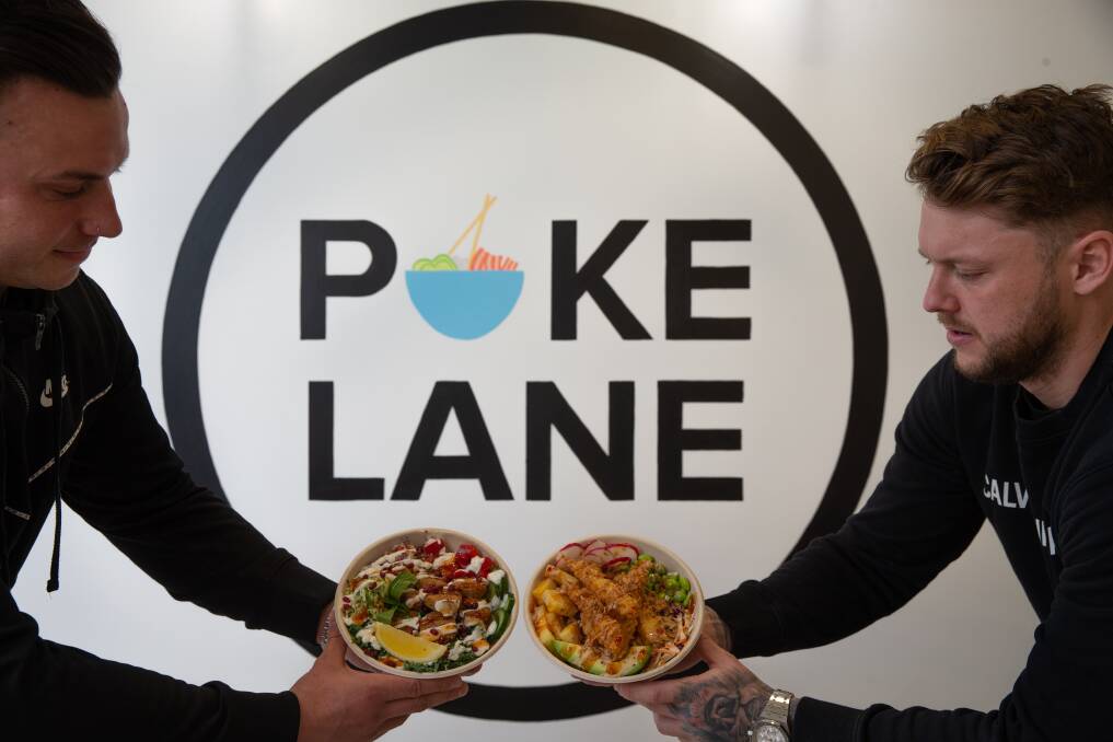 Ready to serve: Kurt Murphy and Cameron Holland of Poke Lane with a prawn and falafel poke bowl. Pictures: Marina Neil