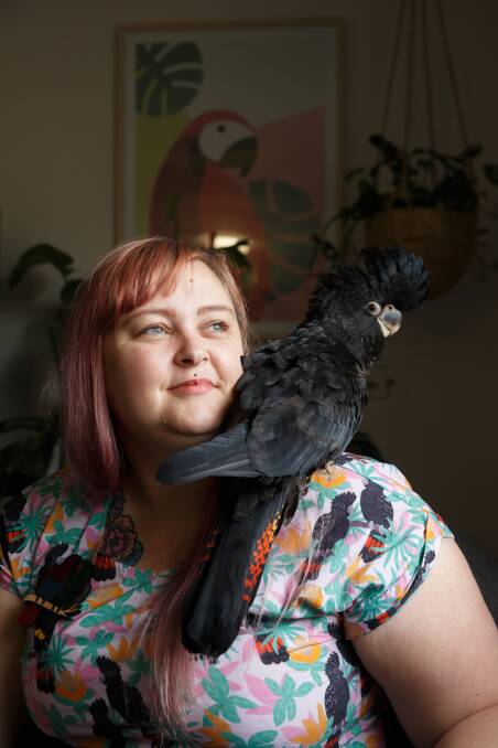 Bird lover: Caitlin Lee with Eddy, a rescued juvenile red-tailed black coctaoo. Picture: Max Mason-Hubers.
