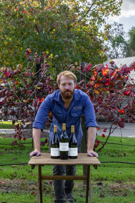Briar Ridge winemaker Alex Beckett with three of his new vintage red wines.