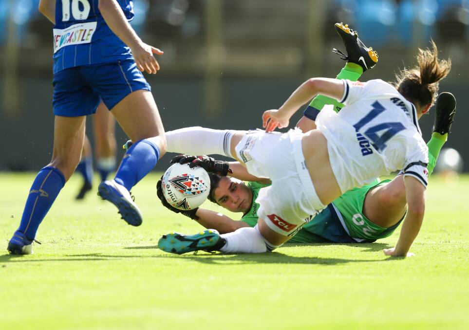 On the job: Newcastle Jets goalkeeper Claire Coelho makes a great save against Melbourne Victory. Picture: Jonathan Carroll