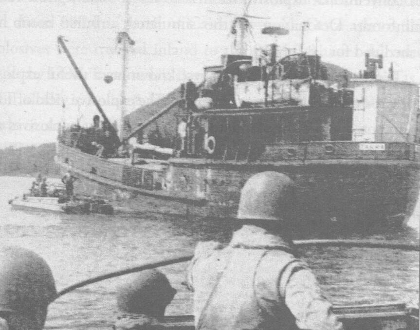 Army action at Bay: Soldier/sailors come alongside Tarra to discharge cargo during a Port Stephens exercise in March 1963. 