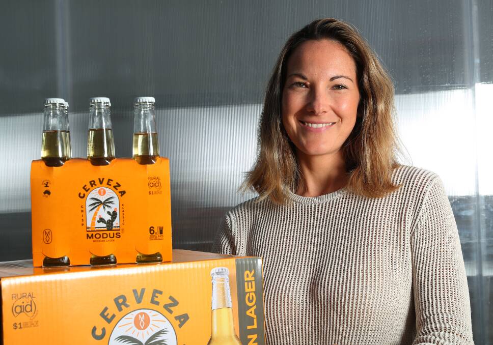 Modus Brewing chief Jaz Wearin with one of the company's newest products, Modus Cerveza in bottles, brewed and bottled at its Merewether brewery. Picture by Peter Lorimer