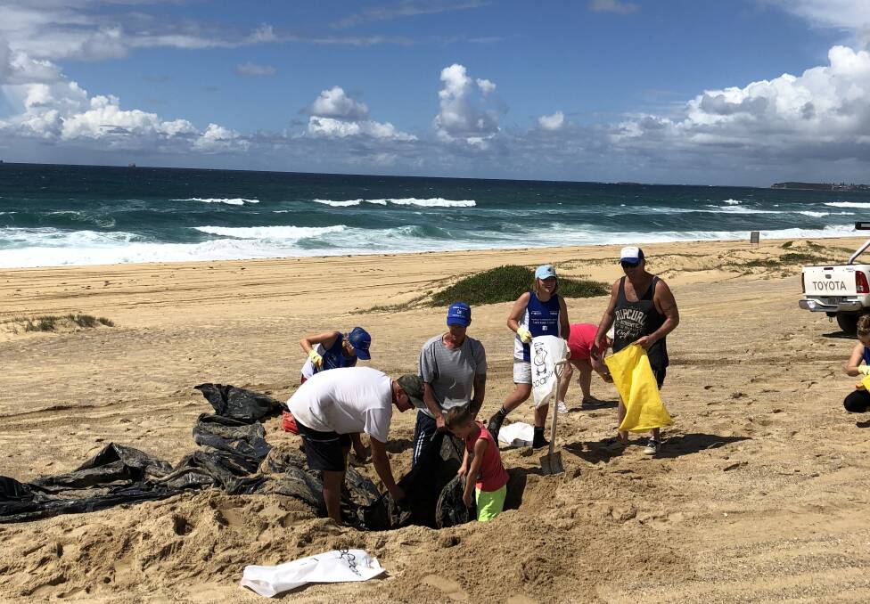 Team effort: Cleanup work by the Redhead to Blacksmiths beach volunteers.