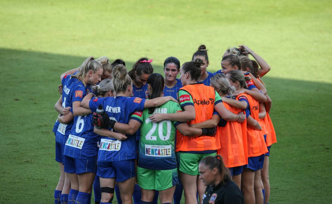 Teamwork: Claire Coelho in the middle of a team huddle. Picture: Marina Neil
