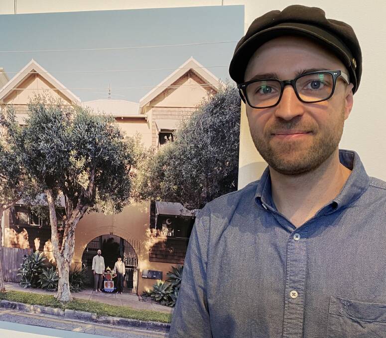 NEW HISTORY: Luke Kellett with an image from his exhibit. Picture: Jim Kellar
