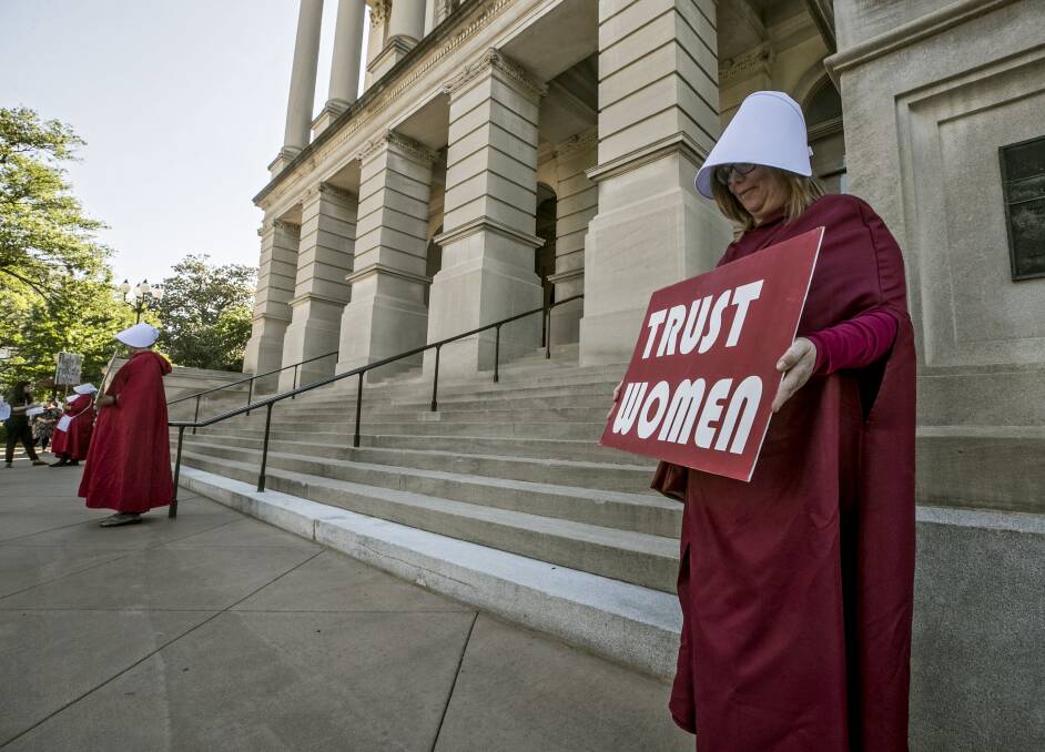 Controversy: Women dressed as characters from "The Handmaid's Tale", protest outside the Georgia capitol building against new laws banning abortion. Picure: AP