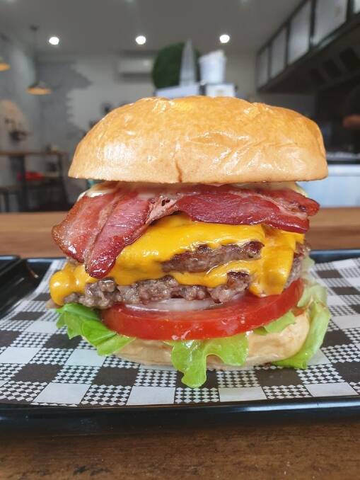 Fiend burger: Beef, cheddar, bacon, lettuce, onion, tomato, pickles, and sauce.