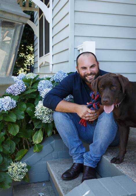 Loving it: Housesitter Dan Cox with Gretel, the pet in the home where he is currently housesitting. Picture: Max Mason-Hubers