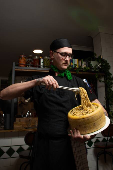 Magic: Chef Zach Miskiewicz with pasta served from a cheese wheel at Lock's Paddock. Picture: Simon McCarthy