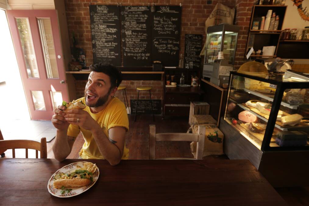 SANDWICH ARTIST: Owner Ali Downer tucks into his beguiling baguette. 