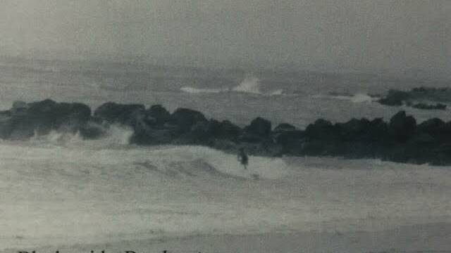 Good old days: A surfer at Blacksmiths before the breakwall was reinforced.