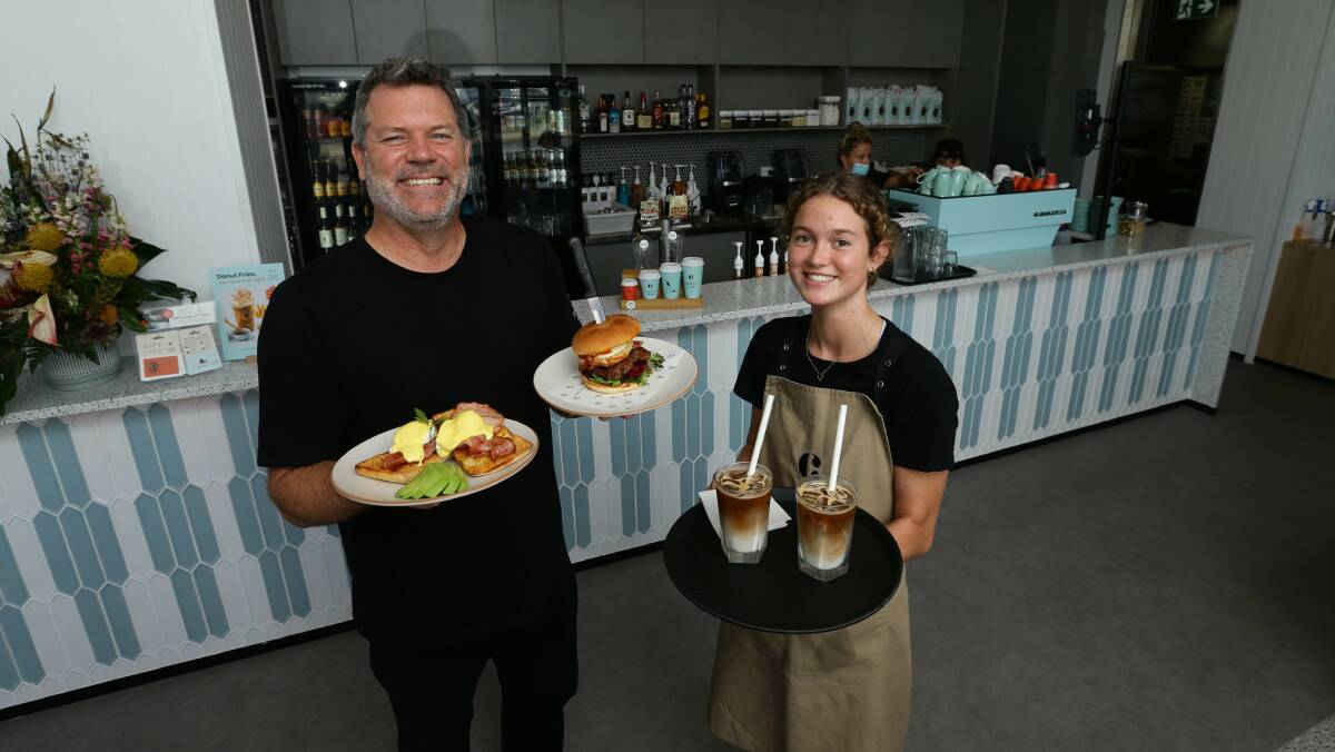 New model: Marty McLean and staff member Hollie Keeble at Marty's new Coffee Club/Burger Bites cafe in Wickham. Picture: Jonathan Carroll