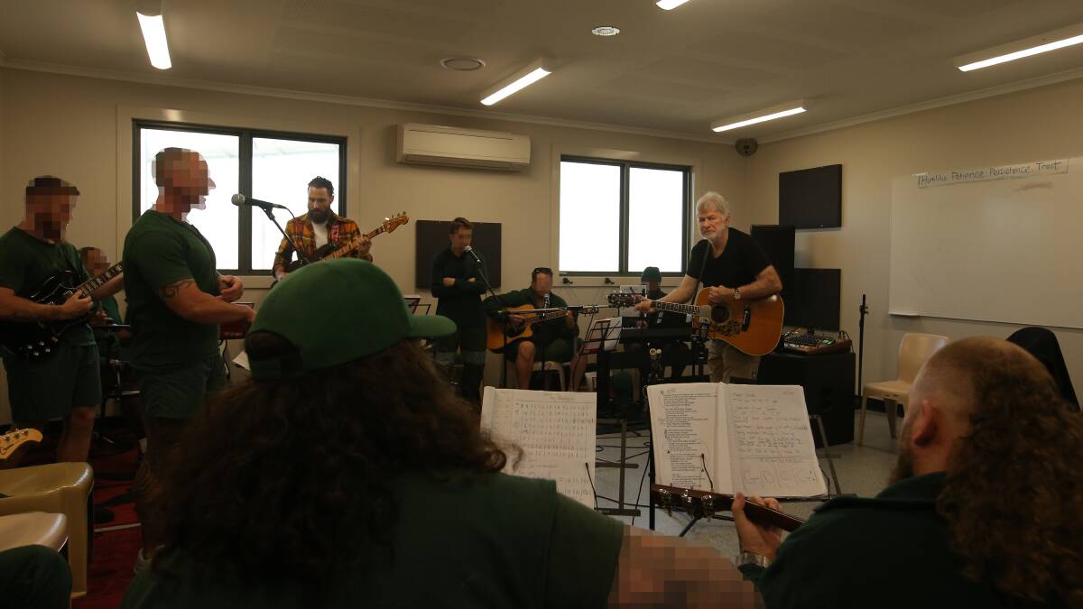 William Crighton and Redgum founder John Schumann working on music with inmates at the Cessnock prison earlier this year. Picture by Simone De Peak