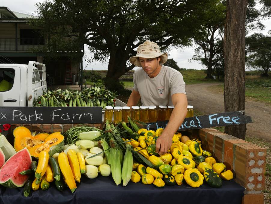 FARM TO PLATE: Jesse Clarke selling his produce. Picture: Jonathan Carroll