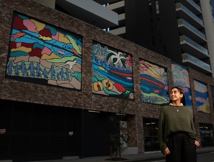 Welcome: Jasmine Craciun in front of her Station Street, Wickham, mural. PIcture: Marina Neil