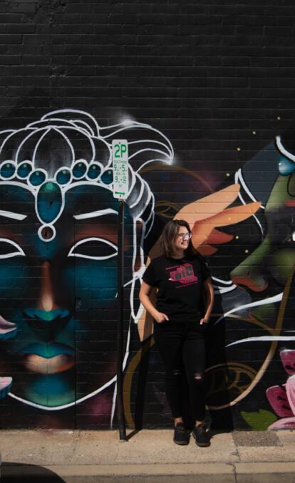New work coming: Becky Kiil, director of The Big Picture Fest coming to Newcastle October 2-4, in front a new mural by Jordan Lucky in Civic Lane, Newcastle. Picture: Marina Neil