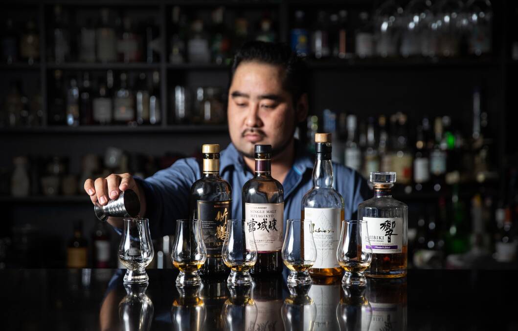 Quality: Nagisa restaurant owner Taiyo Namba with the five drinks in the whisky taster. Picture: Marina Neil