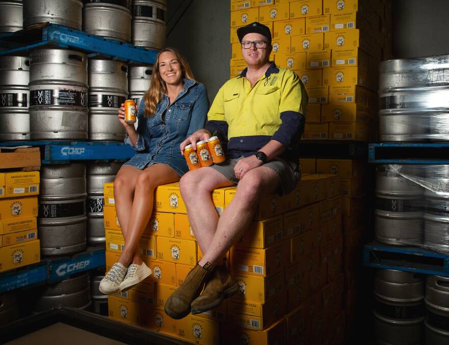 Modus Operandi founder Jaz Wearin and head brewer Matt Hogan with their Cerveza product fresh off the brewing line in Merewether. Picture by Marina Neil