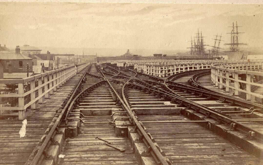 LANDMARK: Elevated rail tracks on coal staiths along present Wharf Road in late 1870. Picture: Beaufoy Merlin. In the distant centre left is the Crown Street rail bridge.