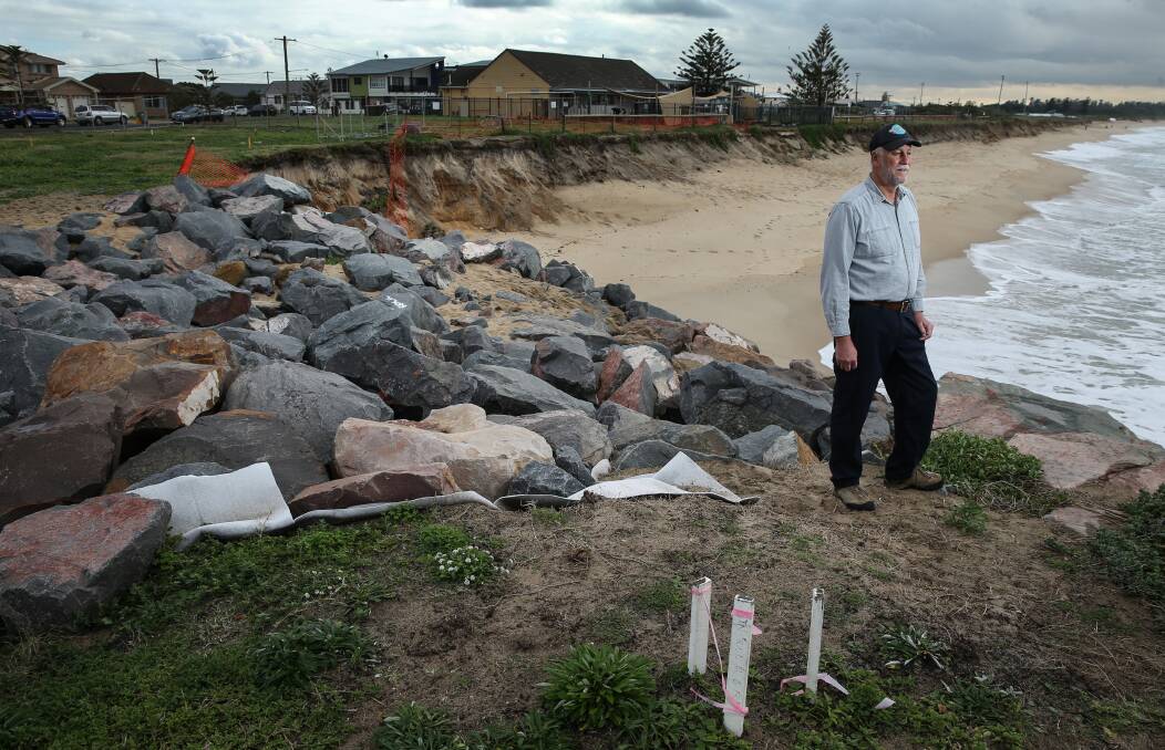 Concerned: Ron Boyd, pictured, has written an analysis of the Stockton Beach erosion problem and how to solve it. This photo, taken in July, shows erosion directly behind the Mission Early Learning Centre (black pool fence) and nearby works where council have dumped rocks. Picture: Marina Neil