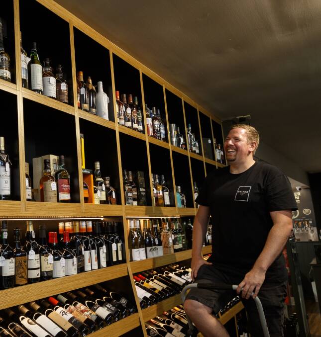 MALTY GOODNESS: Manager Dan Williams at the whiskey wall.