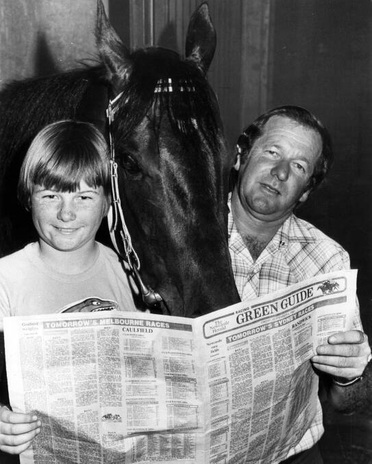 BORN TO RACE: Max Lees with son Kris and racehorse Bourkes Law read a racing guide in 1981.