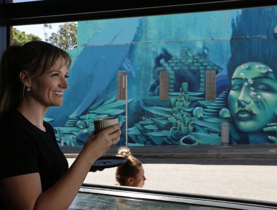 ON TREND: Hayley Sinkinson of Praise Joe Urban Pantry loves the cafe's mural by street artist Jordan Lucky. 