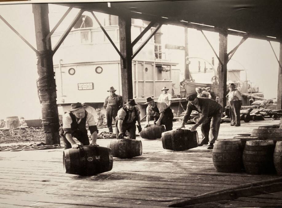 Thirsty work. Labourers roll beer barrels from a Sydney steamer onto a Newcastle wharf. Picture from Newcastle Region Library. 