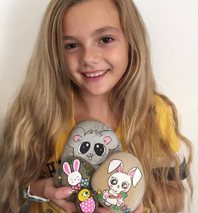 Love it: Elodie Chapman with rocks she has painted for the Easter rock hunt.