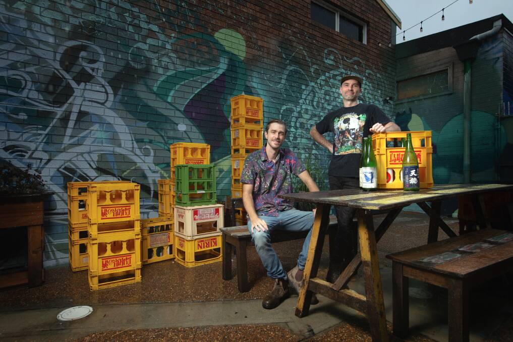 Kicking on: Jam's Karaoke Bar co-owners Joel Hillier (seated) and Andrew Coughlan in their new courtyard. Picture: Marina Neil
