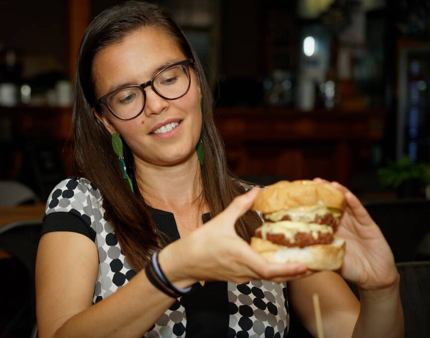 Yummy challenge: Alex Morris with a vegan double cheeseburger burger from Bonta Vera. Picture: Paul Dear