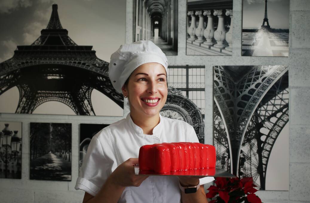 Charline Barre owner of French Faves in Belford Street Broadmeadow with a berries and lemon Xmas mousse cake log. Picture: Simone De Peak