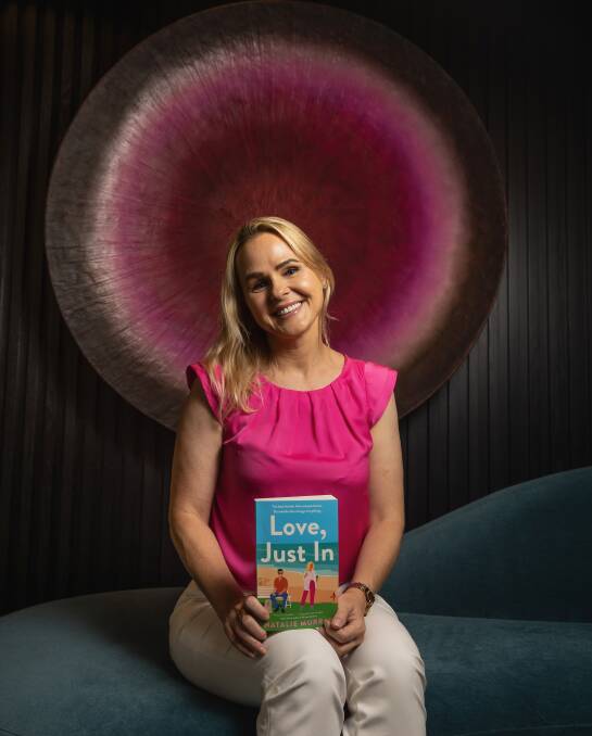 Newcastle-based author Natalie Murray with her new novel, Love, Just In. Picture by Marina Neil