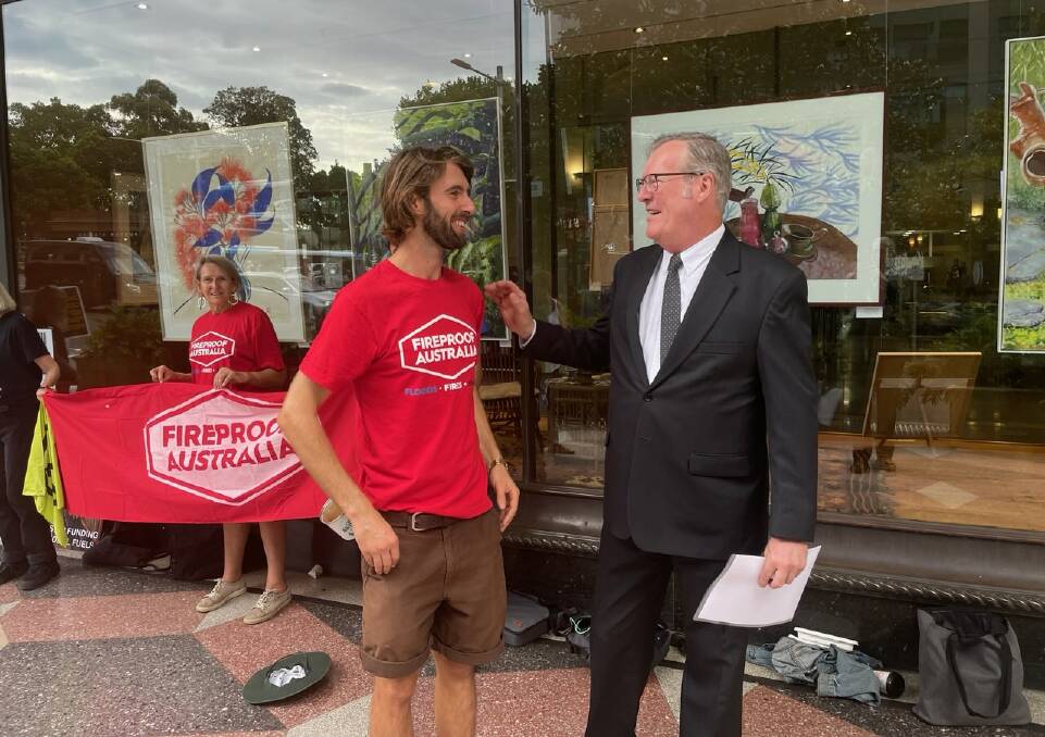 Fireproof Australia activist Andy George talks to Alan Glover, before Glover's court apperance on Tuesday in Sydney.