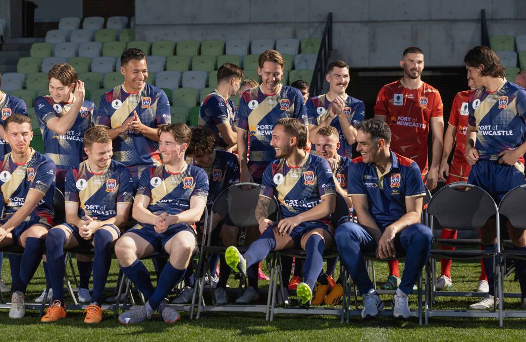 Newcastle Jets head coach Rob Stanton (front row, far left) bantering with his players during a team photo shoot at the start of the A League season. Picture by Marina Neil.