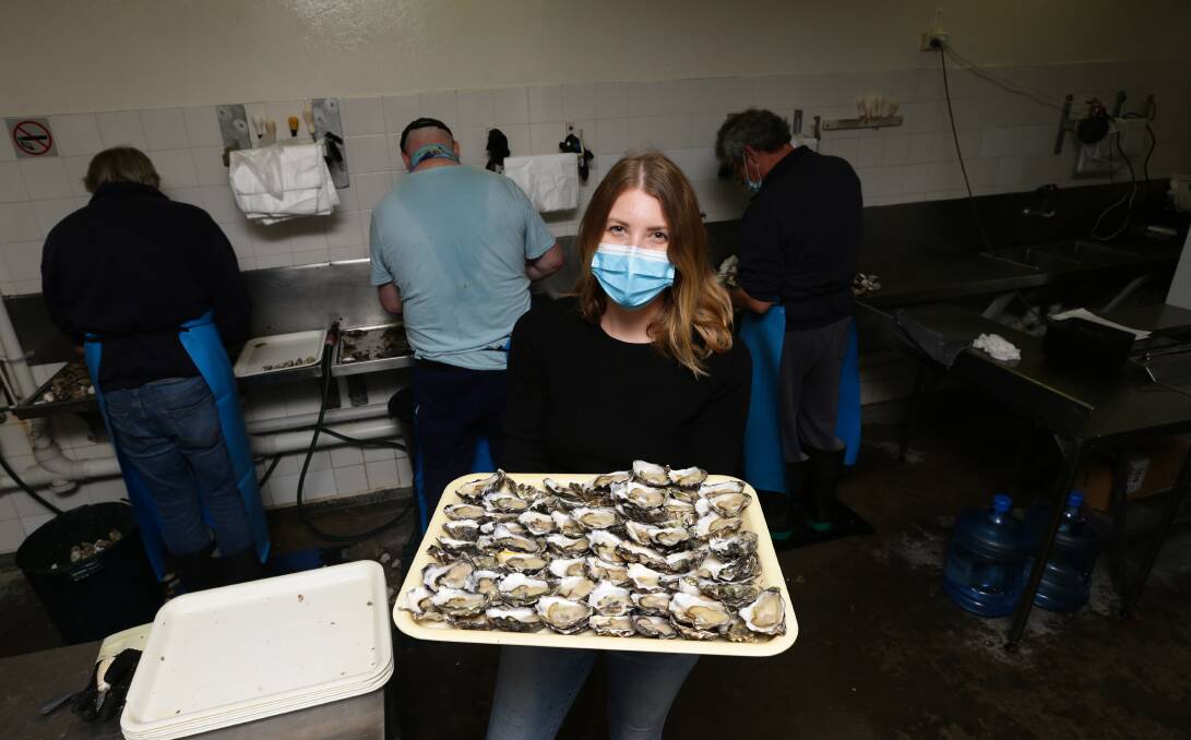 Fresh: Hannah Woods with a tray of oysters as shuckers get through the workload at Dawsons Oysters. Picture: Jonathan Carroll