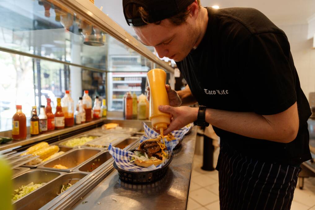 Fresh as: Nathan Szerenga of Taco Locato putting the finish touches on a dish. Picture: Max Mason-Hubers