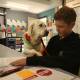Helping hand: Miguel Fenech, 13, with Milly as she looks over his school work at Kotara High School. Picture: Simone De Peak