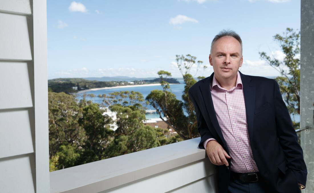 On top of the world: Alloggio managing director Will Creedon on the verandah of a Shoal Bay property that his company offers for tourism accommodation.