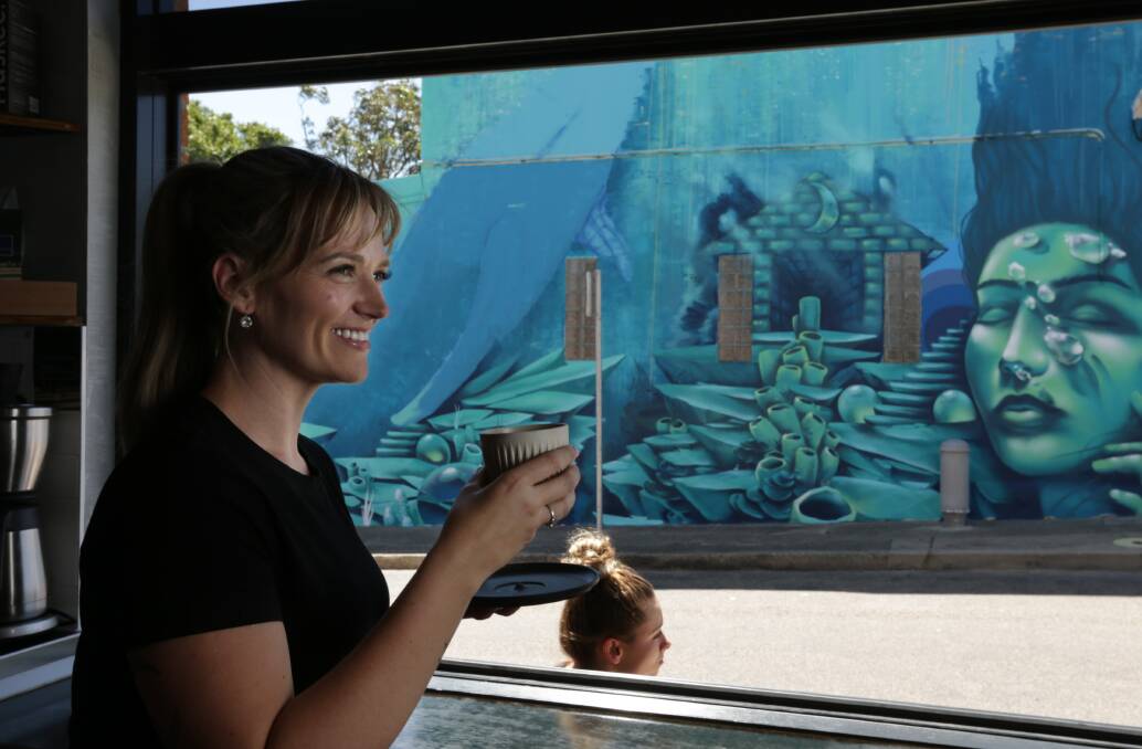 Great neighbourhood: Weekender. Hayley Sinkinson, co-owner of Praise Joe, with a view of the mural they commissioned by street artist Jordan Lucky three years ago. Picture: Simone De Peak.