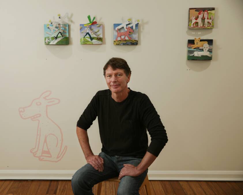 Dog lover: Artist Michael Bell with his work in Curve Gallery. Picture: Simone De Peak