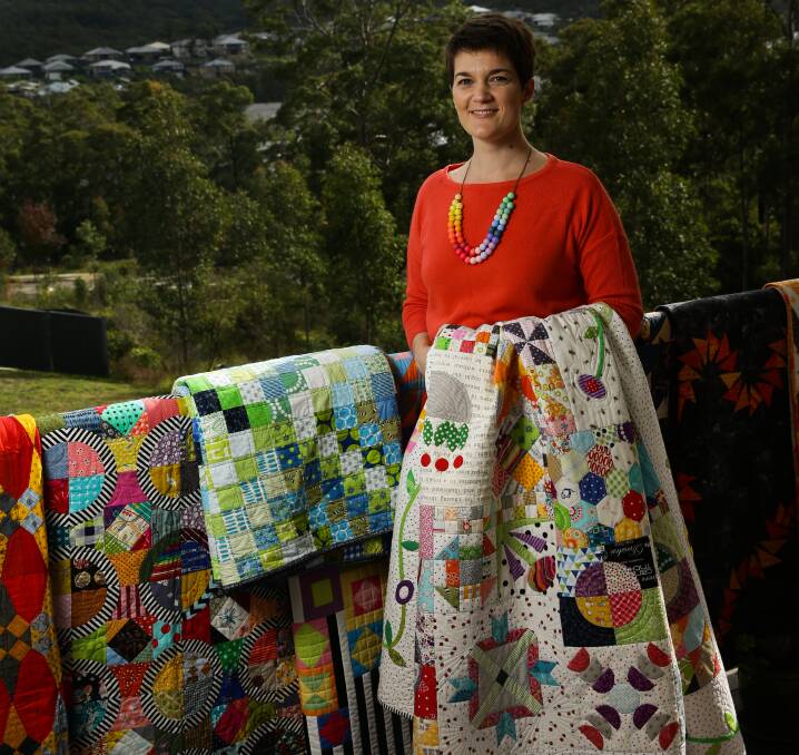A newcomer: Catherine Mosely is relatively new to quilting, but enjoys the creativity. She is shown with some of her work. Picture: Jonathan Carroll
