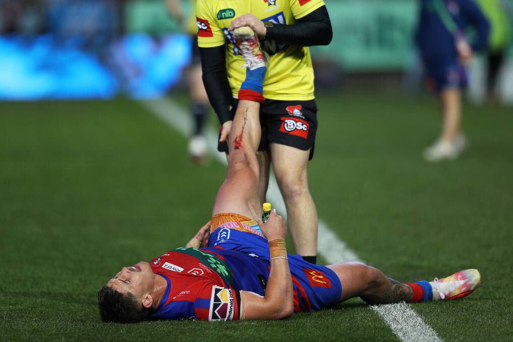 Dylan Lucas treated for a leg cramp in the August 27 victory over the Cronulla Sharks. Picture by Peter Lorimer 