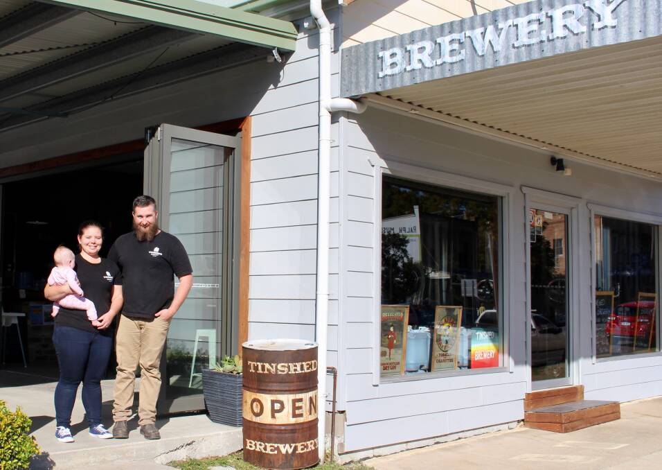 Original brew: Haley Collis and David Cox and their bub outside their Tin Shed Brewery, in Dungog. Picture: Daniel Honan