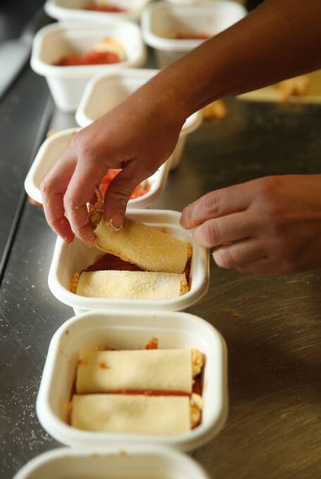Ready to go: Tory Peters packing pumpkin and ricotta cannelloni. Picture: Marina Neil