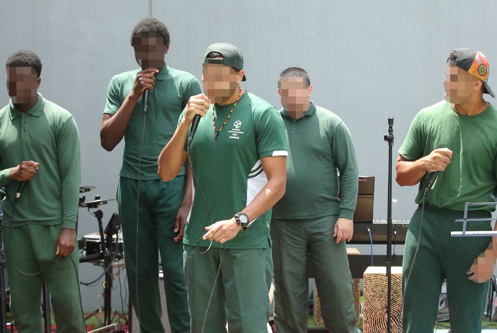 Hunter Correctional Centre inmates performing original hiphop music at the prison's Christmas concert on Monday. Picture by Simone De Peak