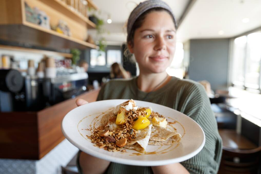 Estabar: Taylor Hunt with the buckwheat pancakes with poached pear and vanilla ricotta. Picture: Max Mason-Hubers