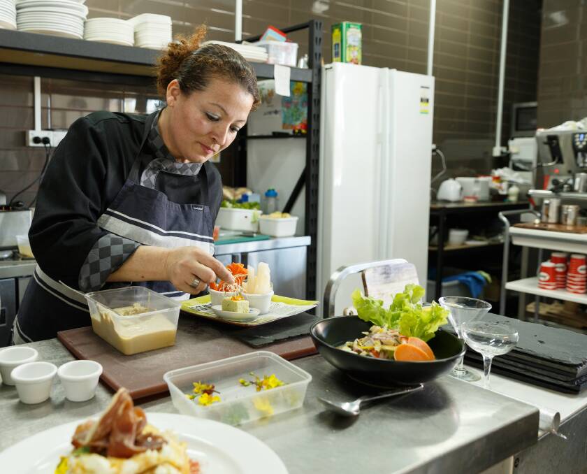 BALANCING ACT: Chef Romy Barbozas plating up a dish in the kitchen. 