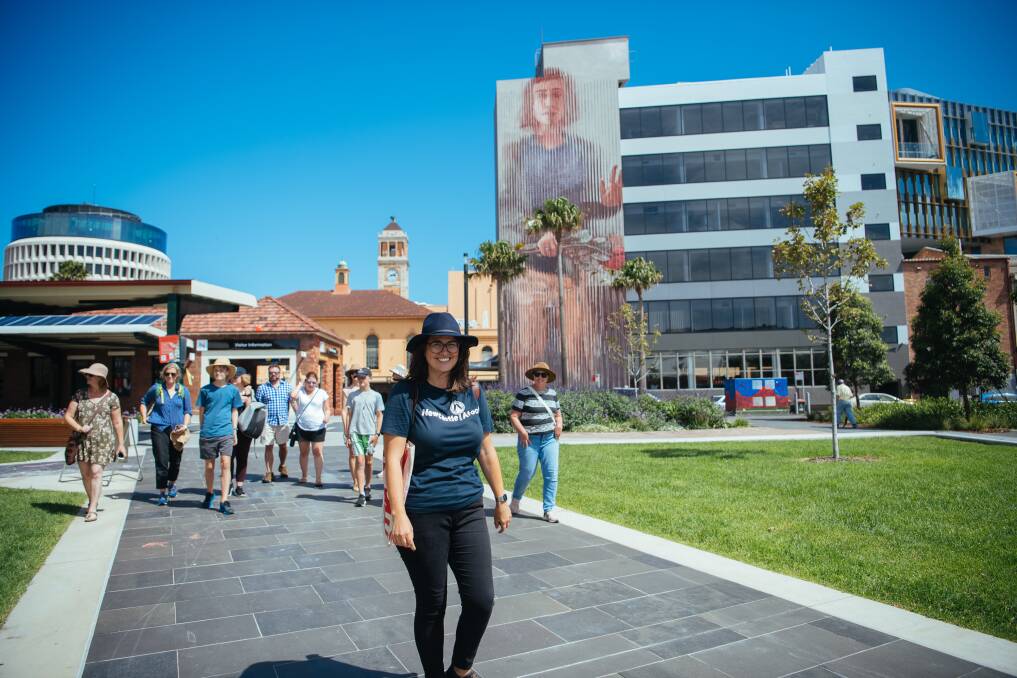 Much more than walk: Newcastle Afoot founder Becky Kiil with a tour group near the Fintan Magee mural in the Civic precinct.