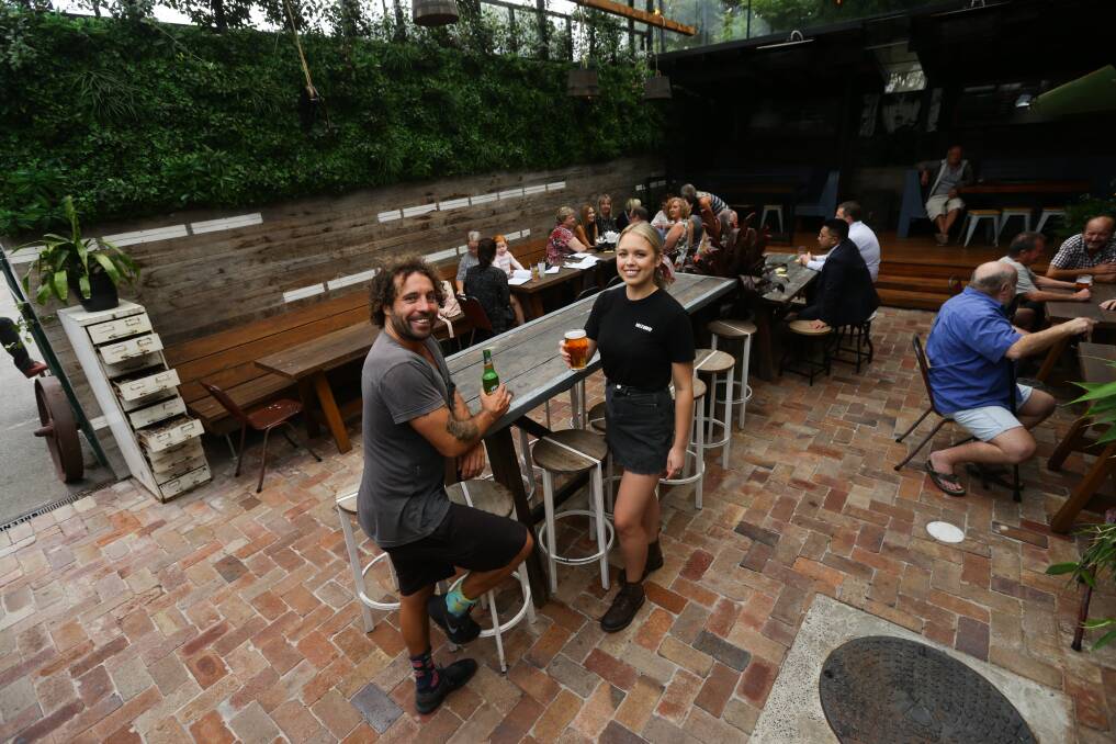 Room to party: Green Roof Hotel staff Cheyne Charles and Lara Carpenter in the hotel's beer garden. Picture: Jonathan Carroll